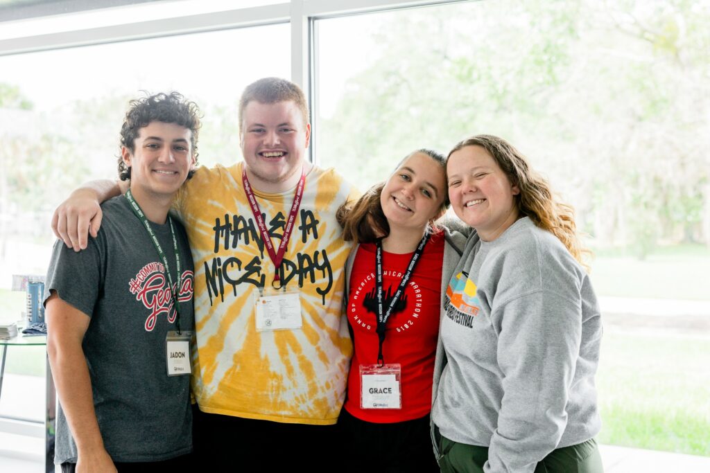 four teens posing