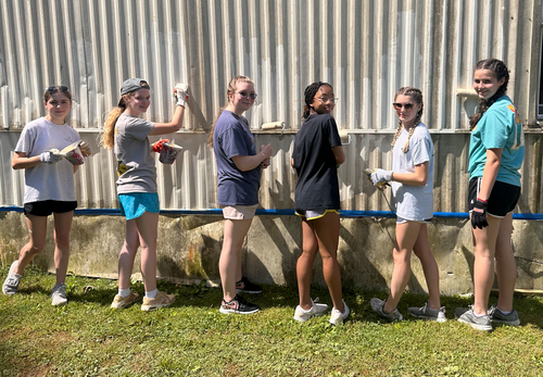 teen girls painting wall