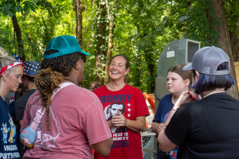 woman smiling with others looking on